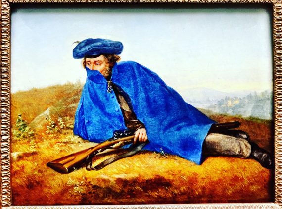A imagem mostra a reprodução do quadro Auf Vorposten, de Georg Friedrich Kersting. Há um homem deitado sobre a relva. Ele está armado, usa uma capa azul e uma expressão infeliz.
